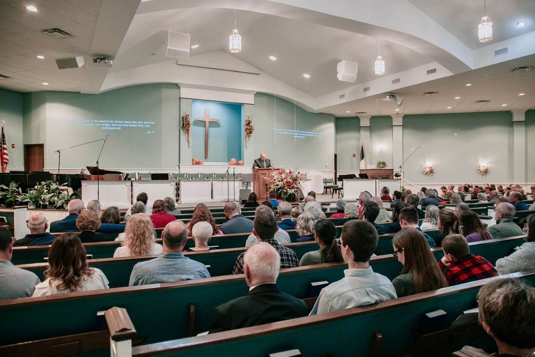 A congregation listening to a sermon in a church sanctuary