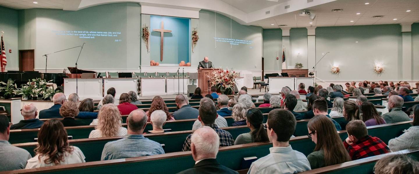 A congregation listening to a sermon in a church sanctuary