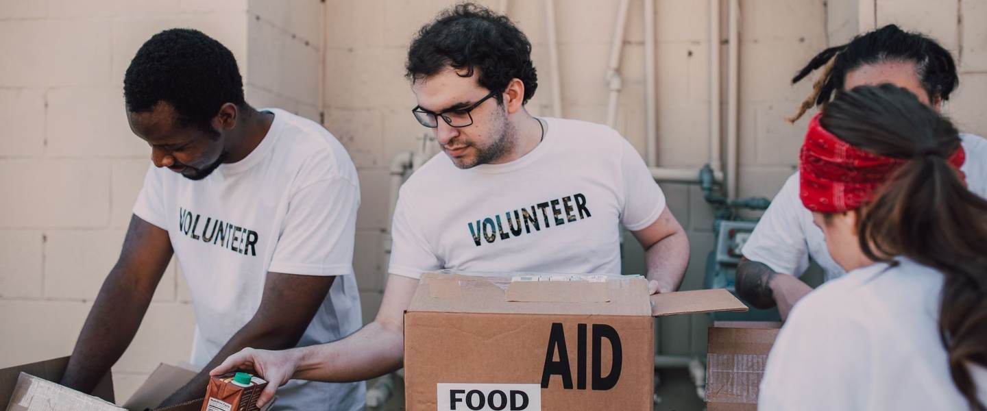 Volunteers packing food into donation boxes